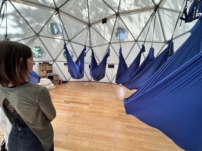 Blue Somatic Swings hung inside the Aum Dome during a practice session