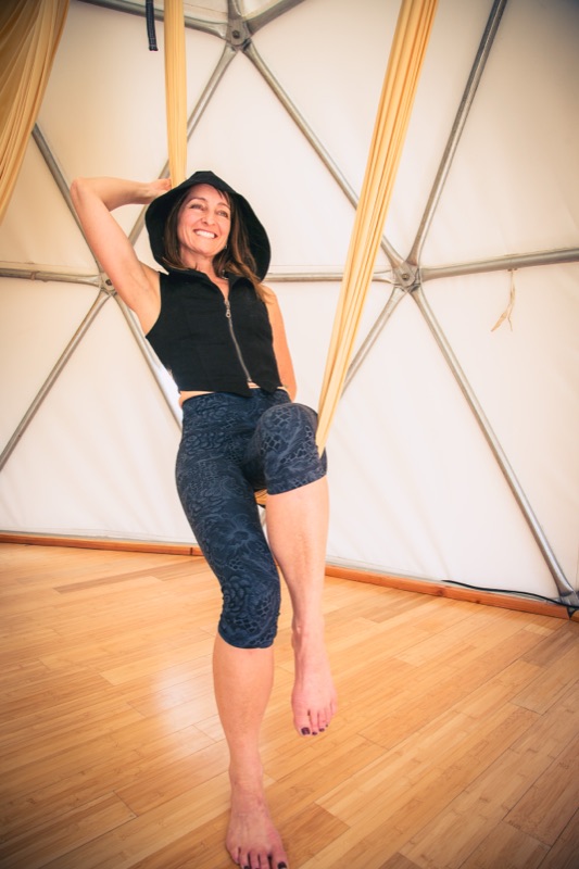 Maura Rassman in a gold Somatic Swing inside the Aum Dome
